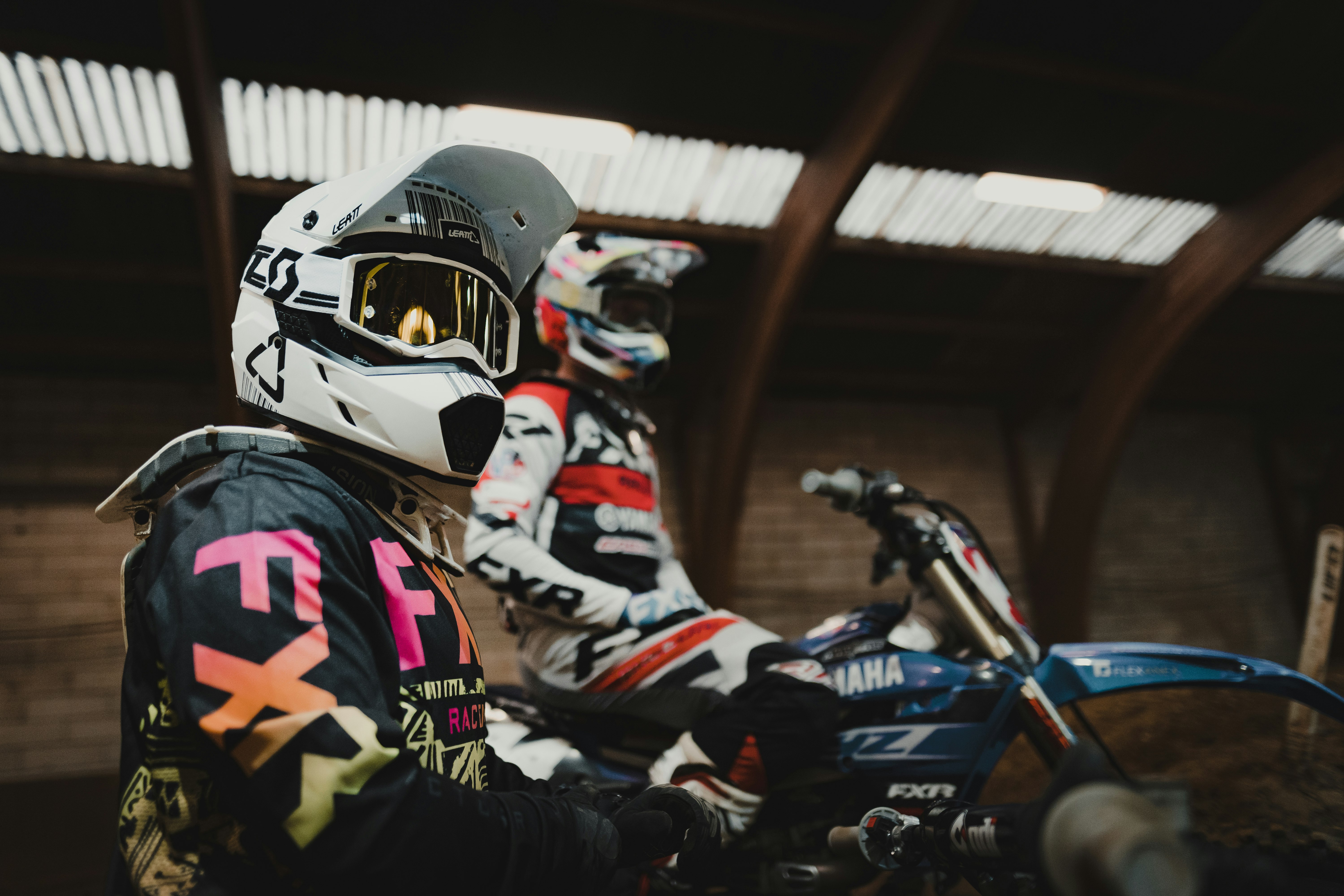 man in black and orange helmet riding blue and white sports bike